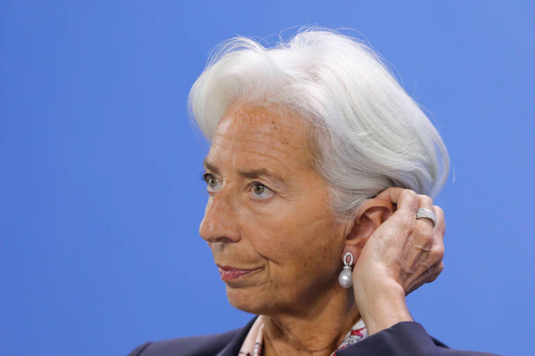 Christine Lagarde rubbing her eat