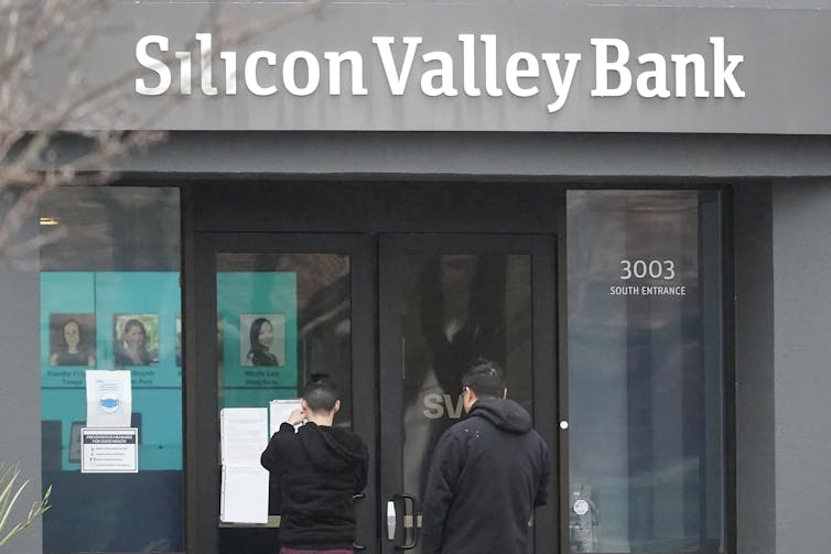 People stand outside of a Silicon Valley Bank