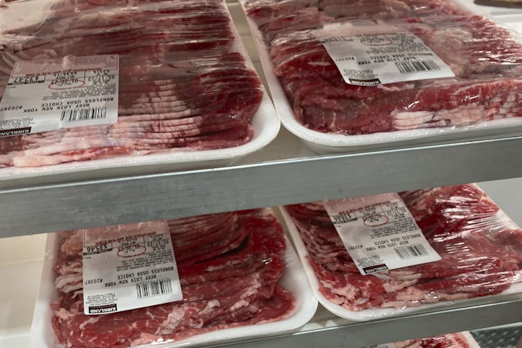packages of beef are on display at a food store