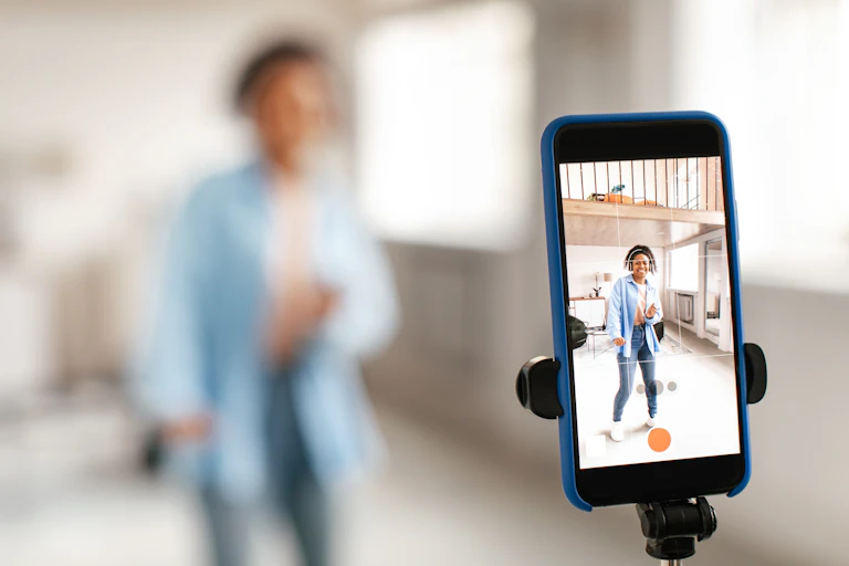 A girl films herself on a phone