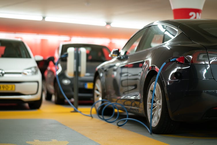 3 EV's parked in a garage and charging.