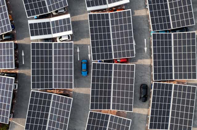 Parking lot solar panels cover all the stalls. The rows are slightly curved.
