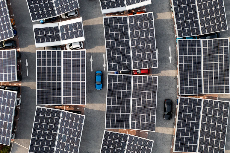 Parking lot solar panels cover all the stalls. The rows are slightly curved.