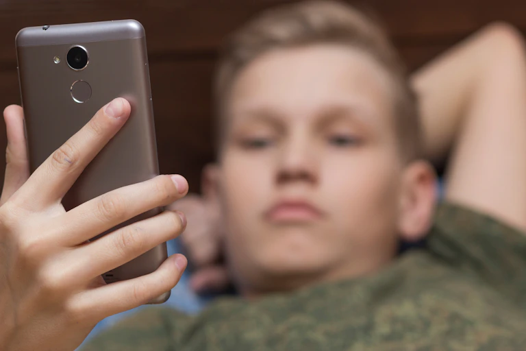 Teen boy looking at phone