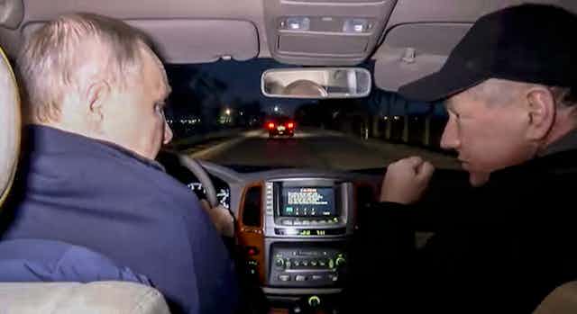 Vladimir Putin with deputy prime minister Marat Khusnullin drive a car through Mariupol in southeastern Ukraine.