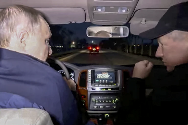 Vladimir Putin with deputy prime minister Marat Khusnullin drive a car through Mariupol in southeastern Ukraine.