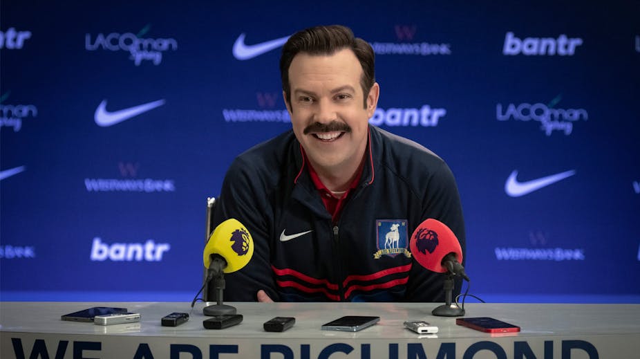 Ted Lasso speaks at a press conference.