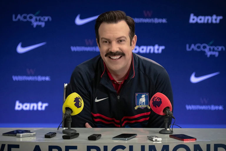 Ted Lasso speaks at a press conference.