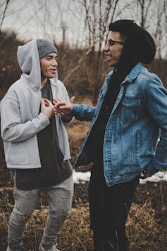 two young men joking with each other