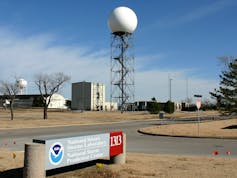 A tall metal tower with a spherical radar receiver on top.