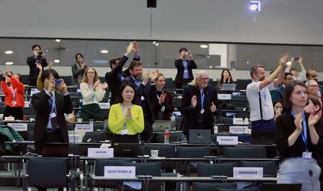 Delegates celebrate the approval of the latest IPCC report