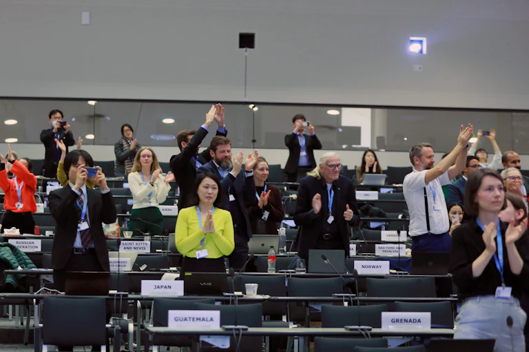 Delegates celebrate the approval of the latest IPCC report