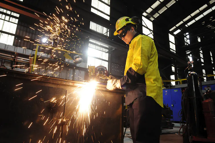 A trainee steel worker in a workshop