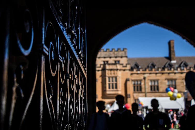 Students walk through the old quadrangle buildings at Sydney University.