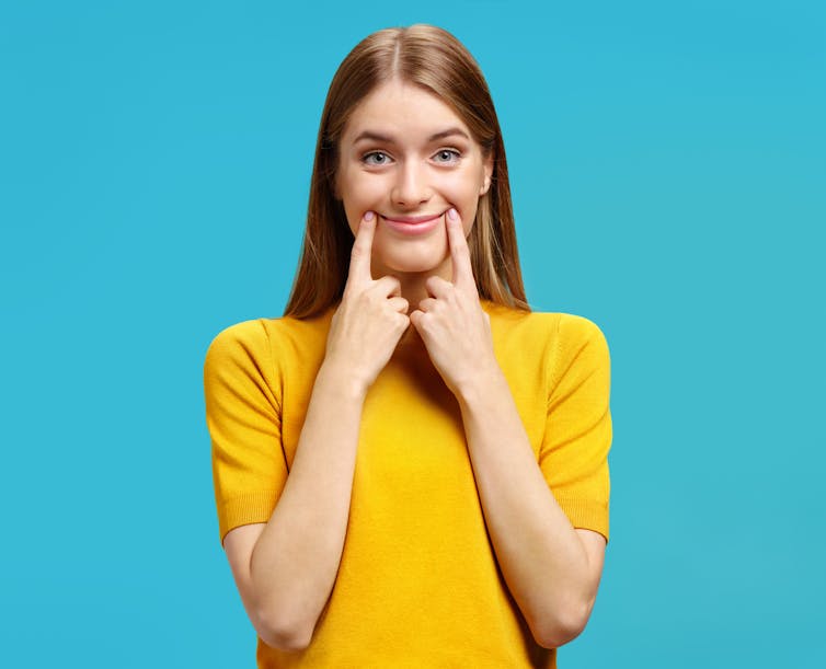 Woman with fake smile.