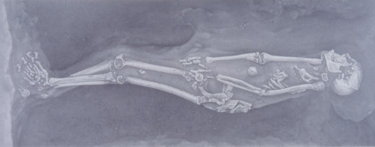 black and white drawing of a skeleton on its side
