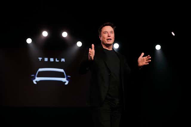 Tesla CEO gives a presentation at the unveiling of a new model