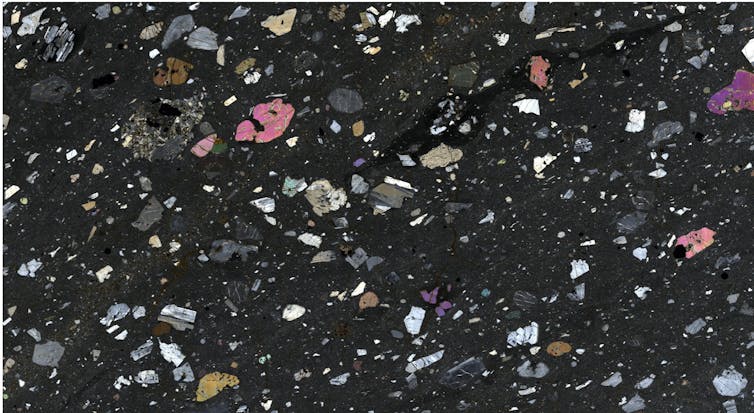 A confetti looking scatter of various specks on a black background