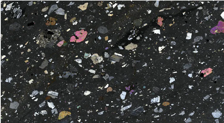 A confetti looking scatter of various specks on a black background