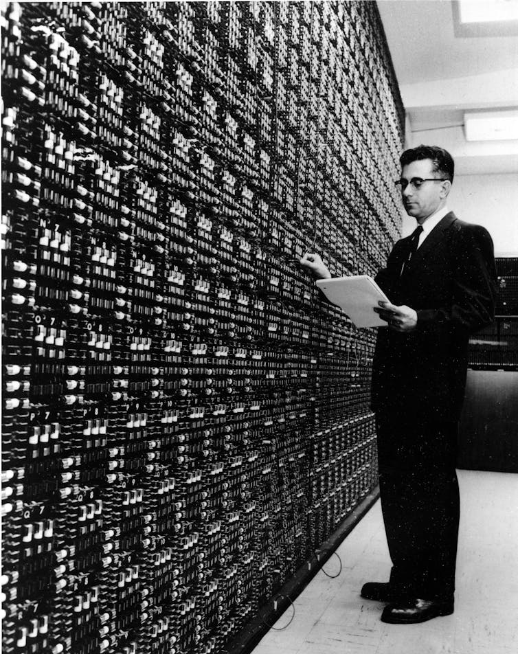 Man standing in front of huge analog computer