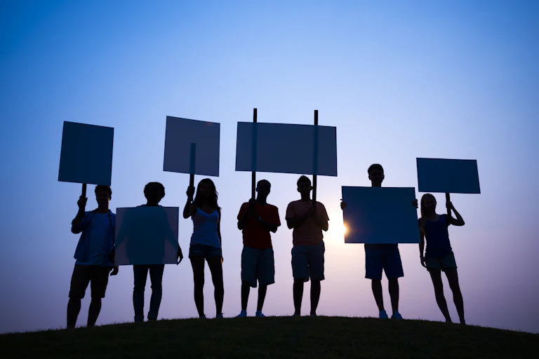 Group of young protesters silhouetted