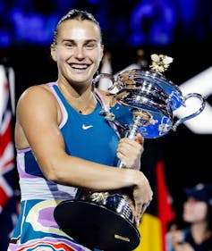 Aryna Sabalenka holding the 2023 Australian Open women's trophy
