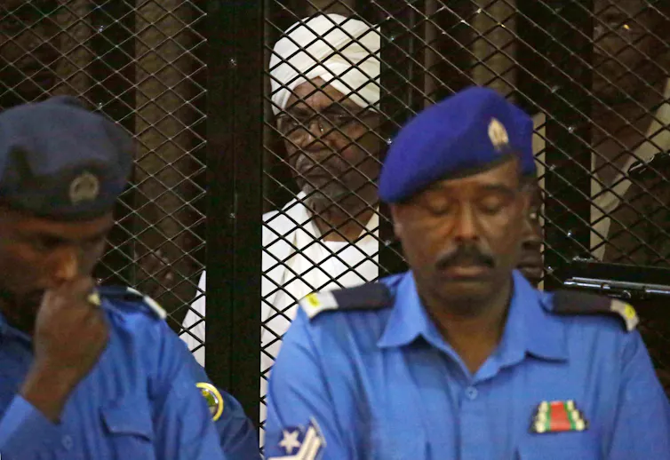 Two uniformed Sudanese police officers stand outside the cell of the former president Omar al-Bashir, who was found guilty of corruption in 2019.