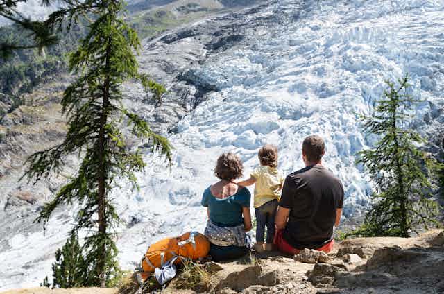 family looks at glacier