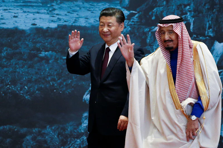 Two men, president Xi and Saudi King Salman of Saudi Arabia, wave towards the camera.