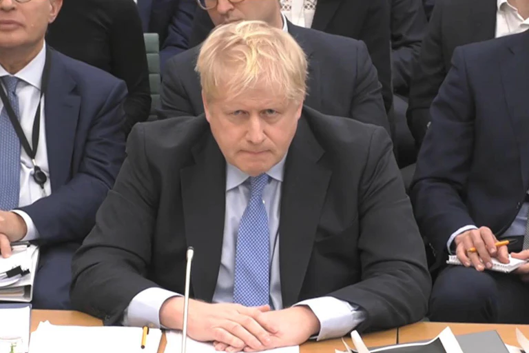 Boris Johnson sitting in a parliamentary committee room giving evidence.