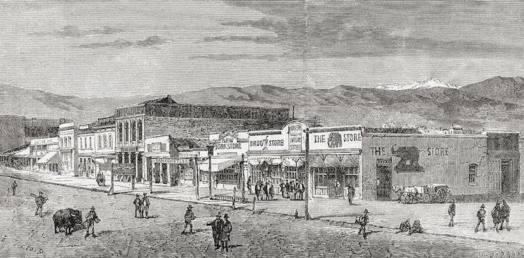 A black and white drawing of a small main street, with mountains in the distance.