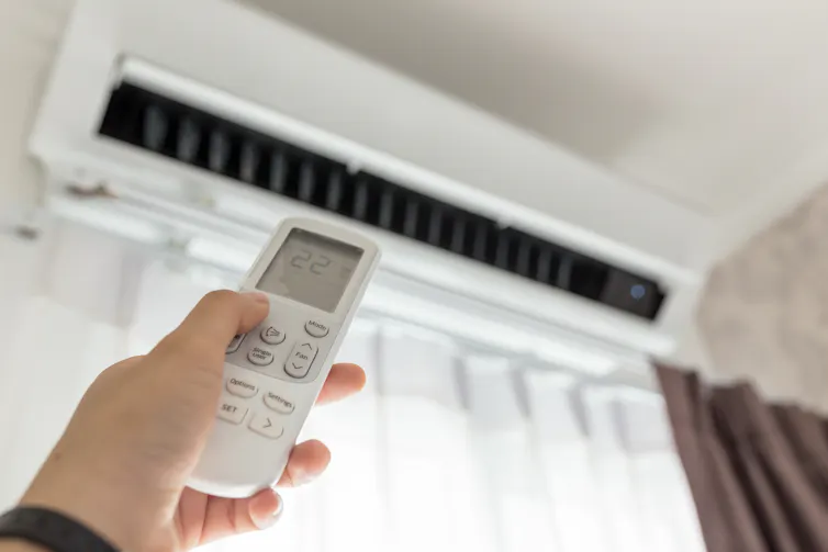 hand points remote control to air conditioning unit
