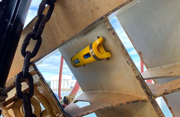 A small sensor in a yellow container is attached to fishing gear.