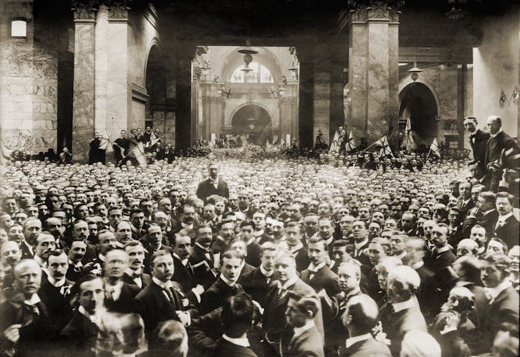 A historical group portrait of many men in suits.