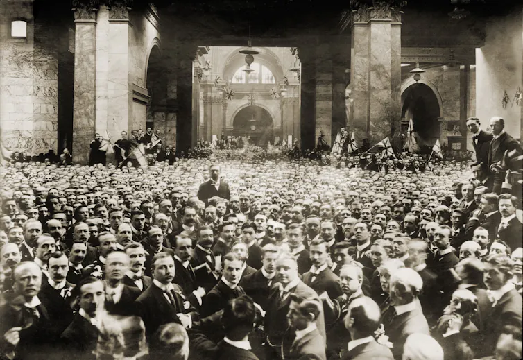 A historical group portrait of many men in suits.