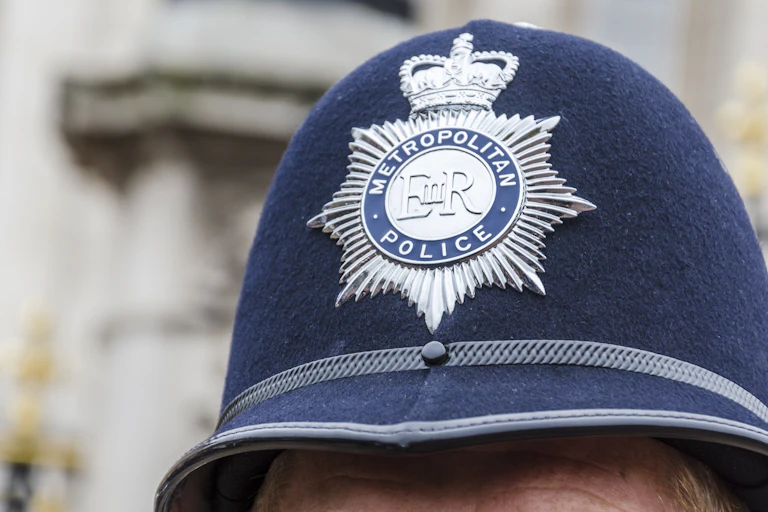 Close up photo of a Met police officer's hat with badge