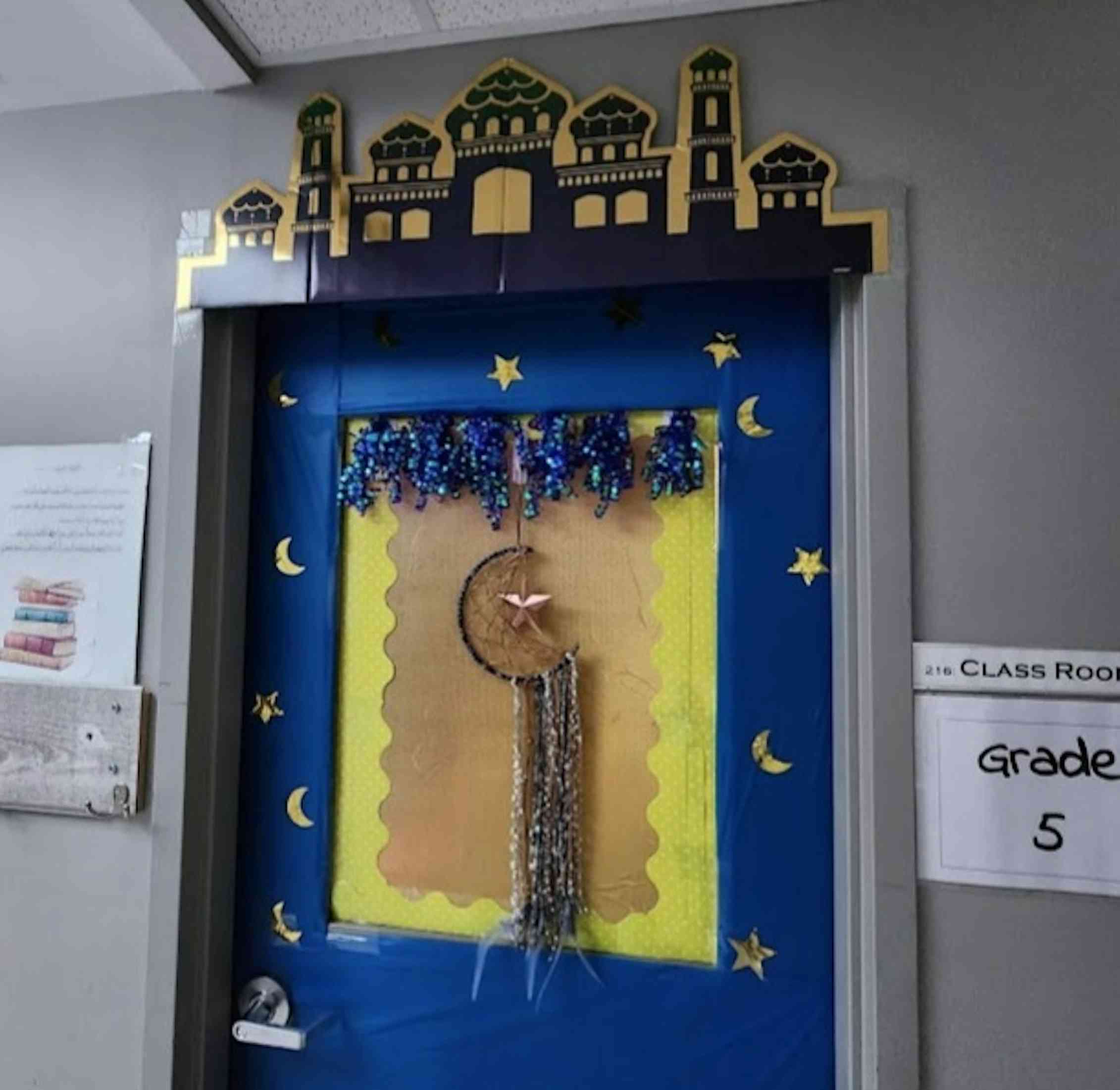 A door seen decorated with a hanging crescent moon.