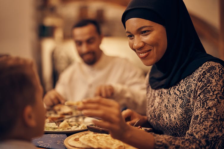 A woman seen smiling at a table.
