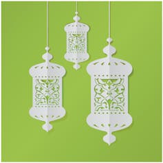 Intricate white paper cut-out lanterns.