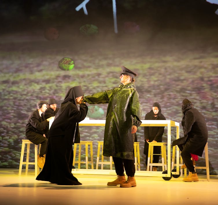 A priest kisses the hand of a soldier.