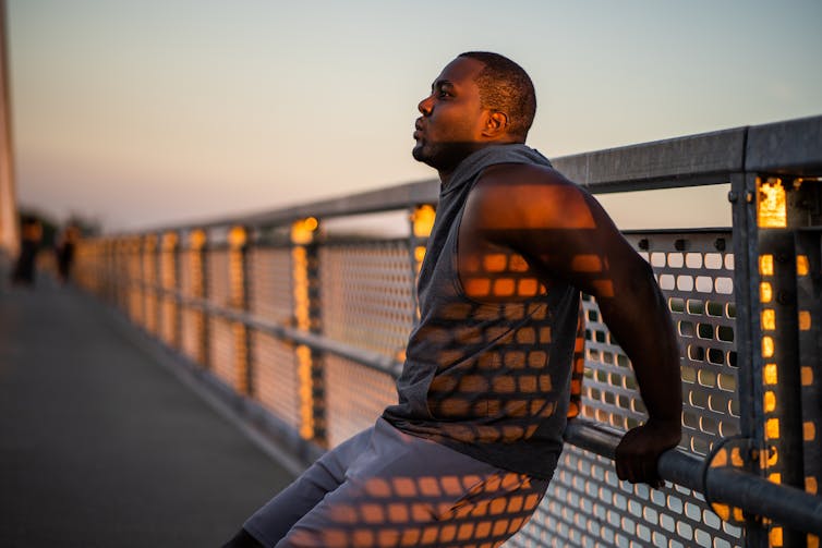 Runner stopped to breathe on bridge