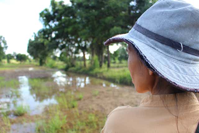 woman in hat looks over outdoor setting