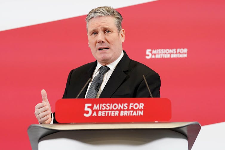 Keir Starmer stands at a podium delivering a speech.