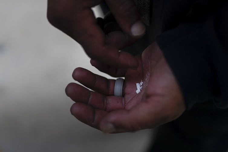 Close-up of hands holding pieces of fentanyl