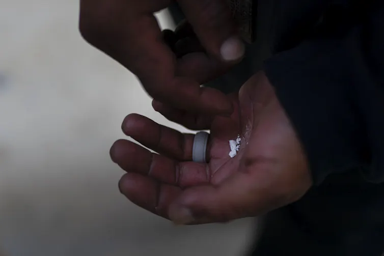 Close-up of hands holding pieces of fentanyl