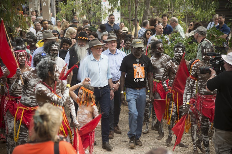 Anthony Albanese walking through group of Aboriginal dancers
