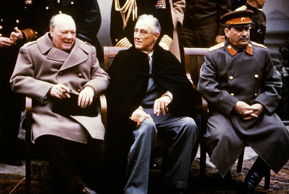 Three men, Winston Churchill, Franklin D Roosevelt and Joseph Stalin, sitting on chairs and talking. 