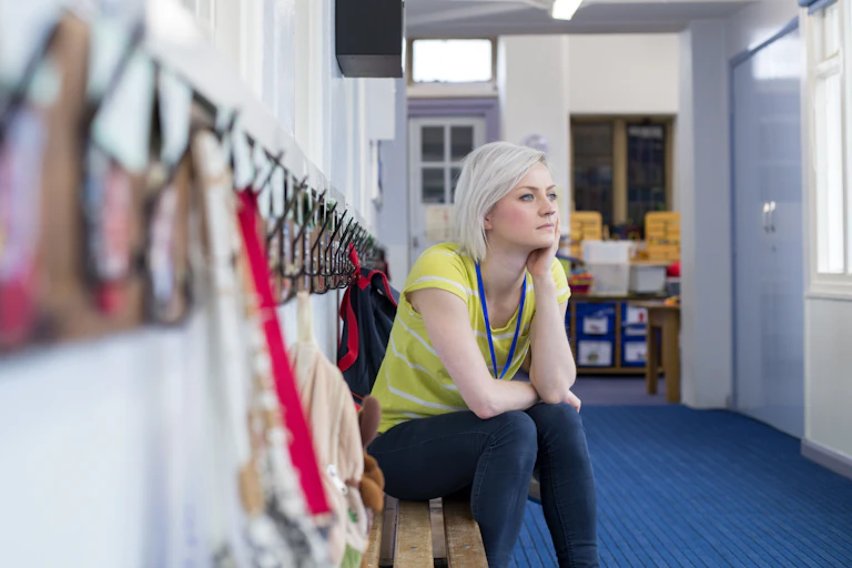 Woman sat in school hallway