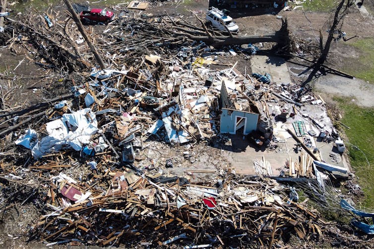 A destroyed home with just one wall standing and furniture strewn about in Rolling Fork, Mississippi, after the tornado March 24, 2023.