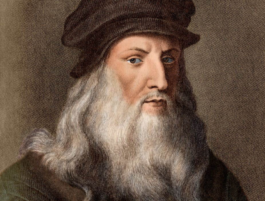 A coloured print of Da Vinci shows him with a long white beard and brown hat. 